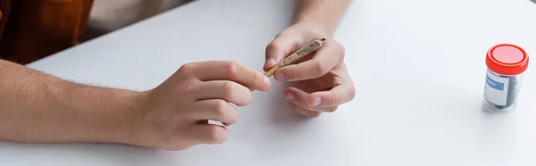 Cropped view of ill man holding joint with medical cannabis, banner — Stock Photo