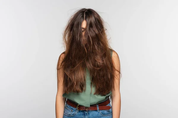 Young woman with tangled long hair isolated on grey — Stock Photo