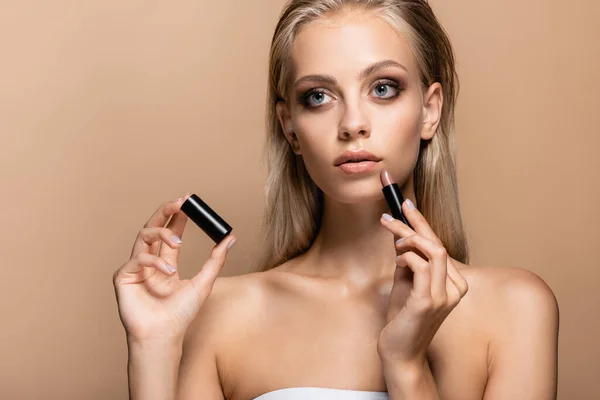 Sensual woman with lipstick looking away isolated on beige — Stock Photo