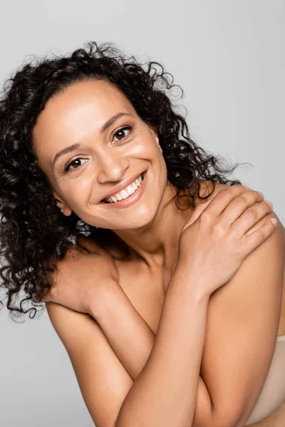 Portrait of smiling african american woman in bra isolated on grey — Stock Photo