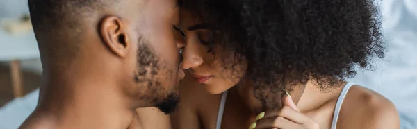 African american man kissing girlfriend in bedroom, banner — Stock Photo