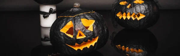 Creepy dark and curved pumpkins on black, banner — Stock Photo