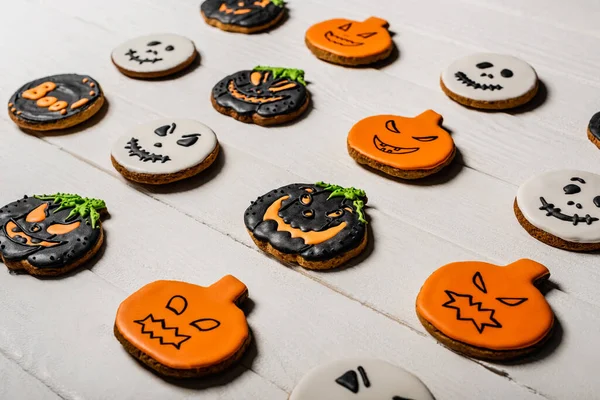 Sweet and spooky pumpkin shape halloween cookies on white surface — Stock Photo