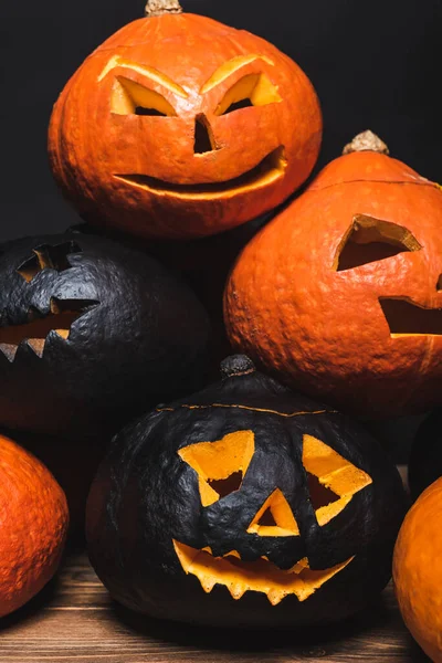 Stack of spooky halloween pumpkins isolated on black — Stock Photo