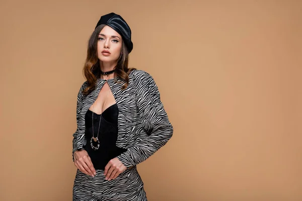 Young woman in zebra print suit and beret isolated on beige — Stock Photo