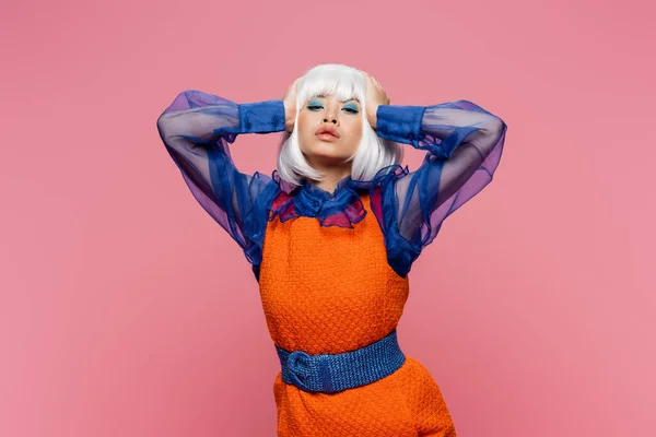 Young asian model in retro clothes and white wig looking at camera isolated on pink — Stock Photo