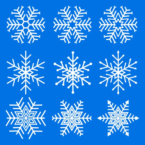 Conjunto de copos de nieve blancos sobre fondo azul. — Archivo Imágenes Vectoriales