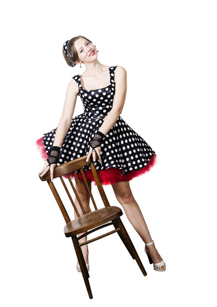 Girl pin-up style, posing with a chair