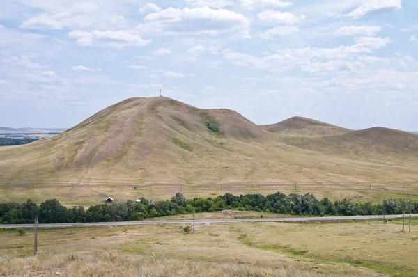 Landscape with a high hill and the road — Stock Photo, Image