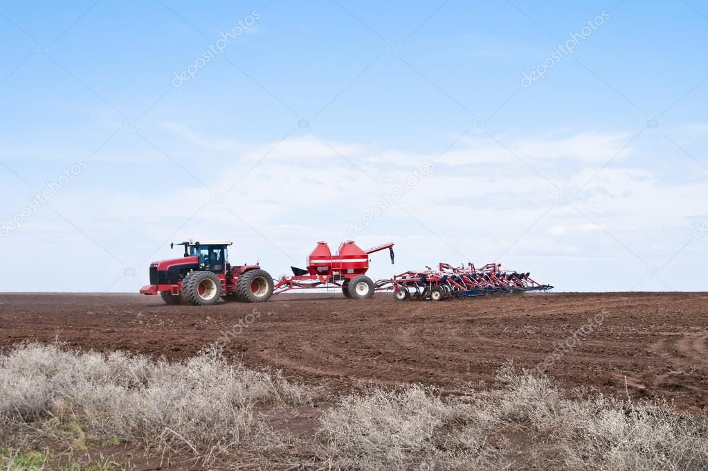 Tractor with seeder in the field