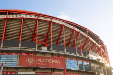 Lisboa, Portekiz 2025-11-09 Sport Lisboa e Benfica 'nın evi Estdio da Luz' un dışı. Stadyumlar kırmızı çelik kirişler ve mimari detaylar yumuşak gün ışığında, Akademi için bir işaret ile