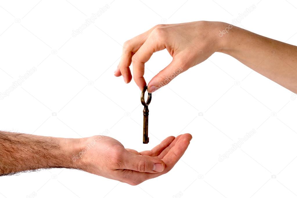 Woman's hand giving a key to a men's hand