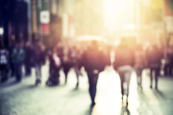 people walking in the street, blurry