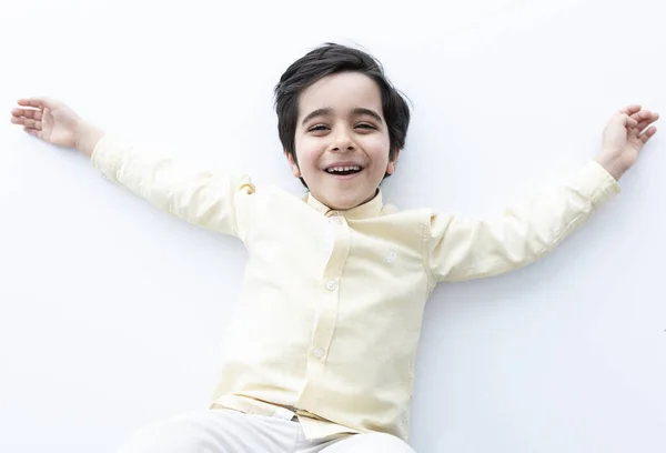 Mutlu ve sevimli küçük çocuk yerde yatıyor..