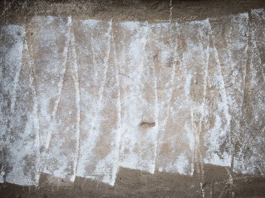 Concrete surface with vertical white brush strokes