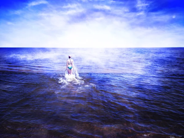 Beautiful young woman walking on shining water towards rising su
