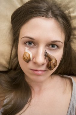 Cosmetic massage with snails clipart