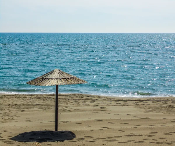Дерев'яний парасолька на піщаному морі — стокове фото
