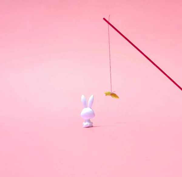 Toy Rabbit Sitting Staring Carrot Stick Pastel Pink Background Photo — Stock Photo, Image