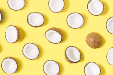 Parlak sarı arka planda taze hindistan cevizi meyvesi deseni. Düz yatıyordu.