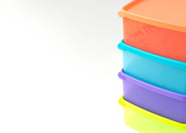 Beyaz arkaplanda izole edilmiş renkli plastik konteyner yığını.