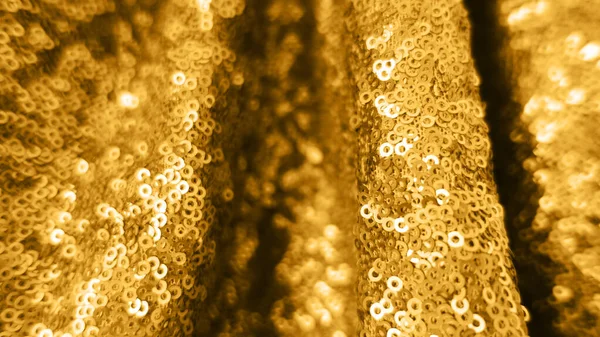 Свято фону з золотих блискіток з глибиною різкості. Металевий яскравий крупним планом блискучий текстиль O — стокове фото
