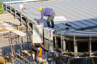 Construction worker doing roof installation clipart