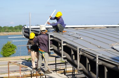 Construction worker roof installation clipart