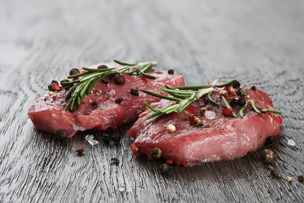 Two raw beef steaks in spicies — Stock Photo, Image