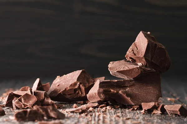 Trozos de chocolate en un fondo oscuro —  Fotos de Stock