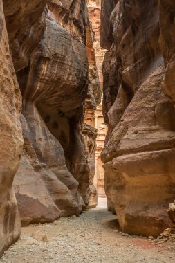Hiking through the canyon in the ancient city of Petra (Jordan)  clipart