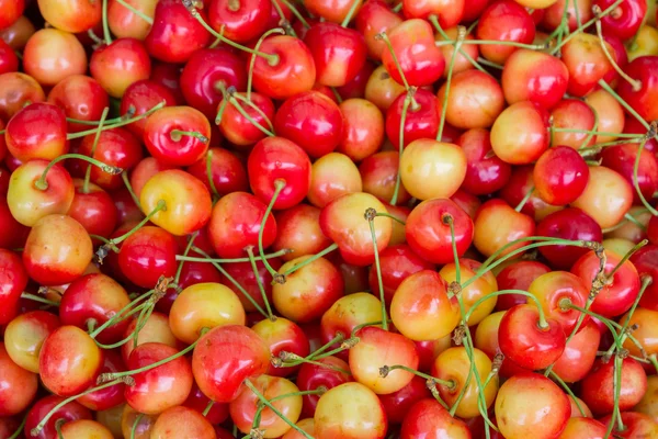 Cerezas dulces de colores maduros en el mercado en el mostrador —  Fotos de Stock