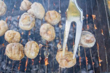 Pickled mushrooms are cooked on the grill on coals
