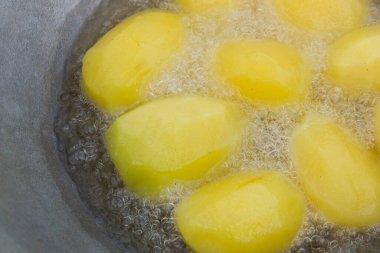 Altın patatesler kazanda kaynar yağda kızartılır.