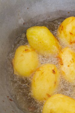 Altın patatesler kazanda kaynar yağda kızartılır.