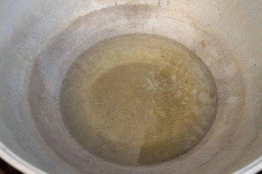 Kömürde pişirmeden önce, bir kazanda yağ kaynatın.