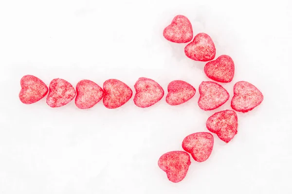 Arrow of pink hearts in the snow — Stock Photo, Image