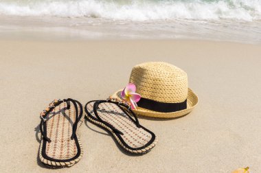Sahilde bir şapka ile plaj terlikleri