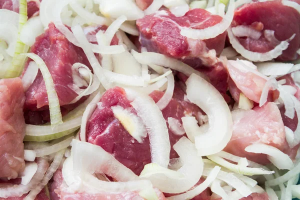 Raw pork meat with onion preparing for barbecue — Stock Photo, Image