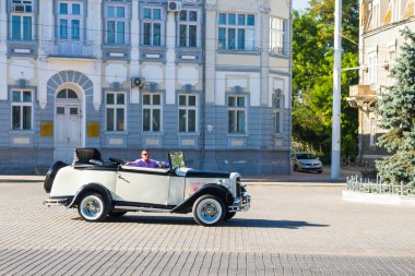 Vintage car with open top on the square in town Yevpatoria