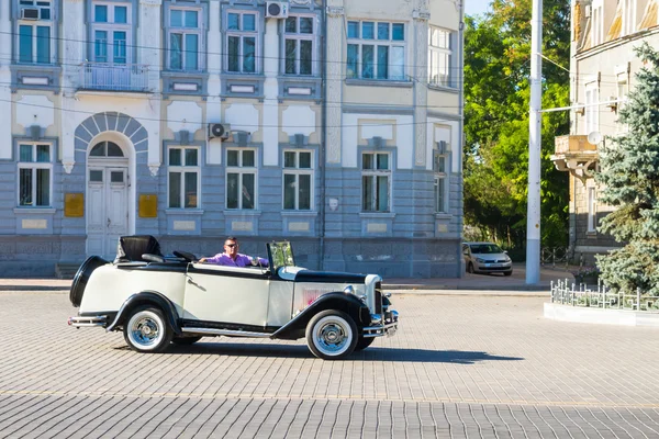 Vintage car with open top on the square in town Yevpatoria