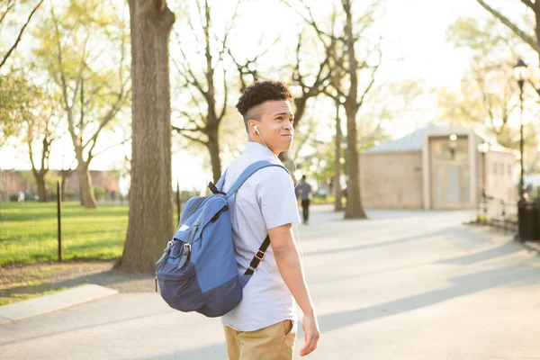 Young Hispanic boy with packpack walk on college campus — Stock Photo, Image