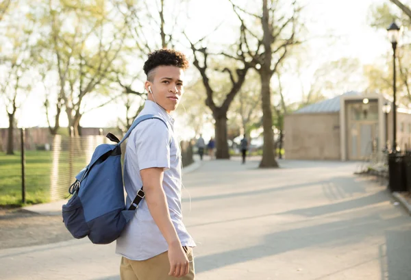 Young Hispanic boy with packpack walk on college campus — Stock Photo, Image