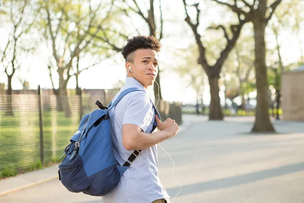 Young Hispanic boy with packpack walk on college campus — Stock Photo, Image
