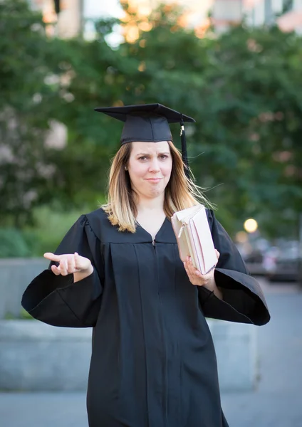 Kvinnliga collegestudent i gradering dag, rynkar pannan för att vara bro — Stockfoto