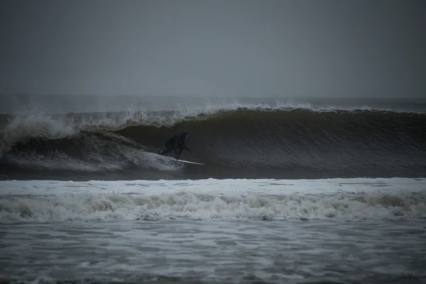 Surfer tucking into a barrel Royalty Free Stock Photos