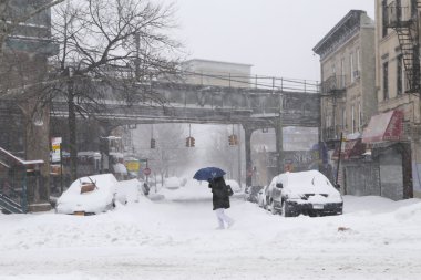 Man walk across the street during snowstorm clipart
