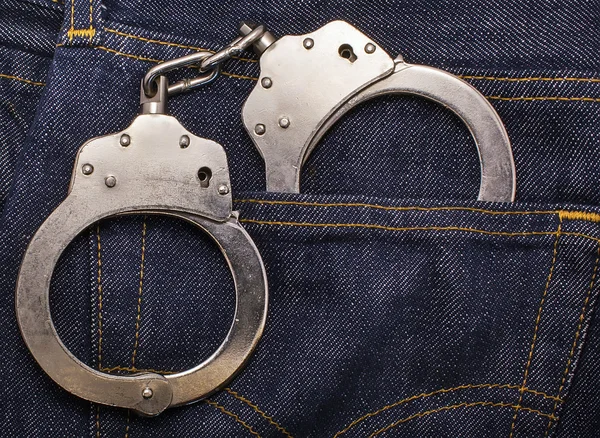 Handcuffs in the  pocket of jeans — Stock Photo, Image