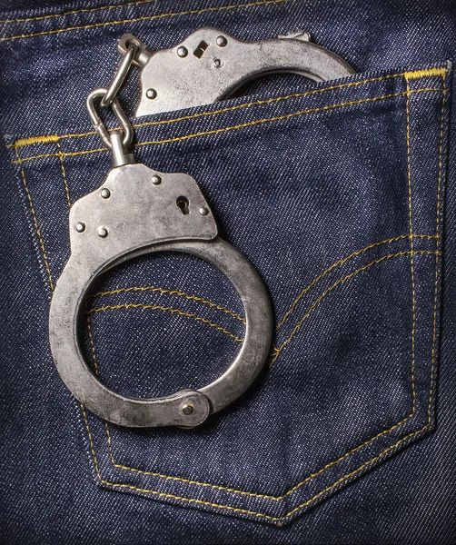 Handcuffs in the back pocket of jeans — Stock Photo, Image