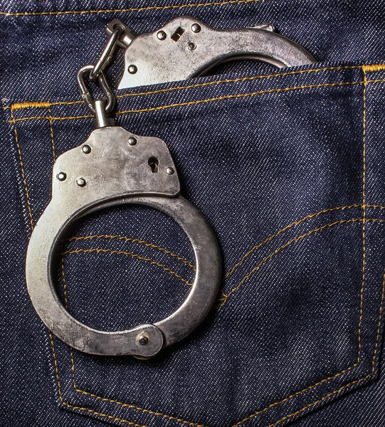 Handcuffs in the back pocket of jeans — Stock Photo, Image